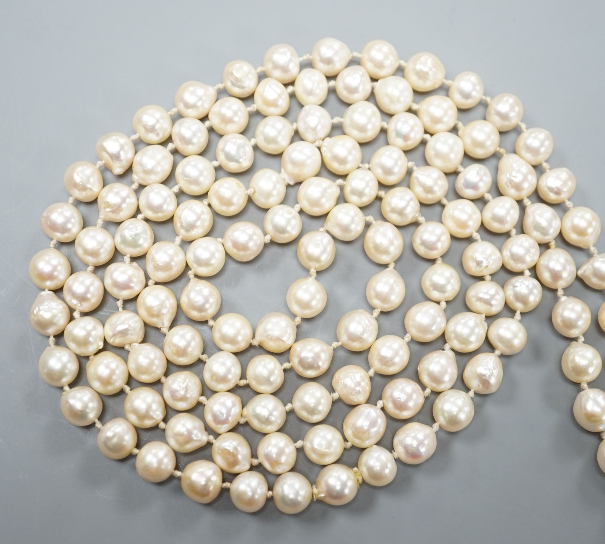 A long single strand baroque cultured pearl necklace, 128cm.